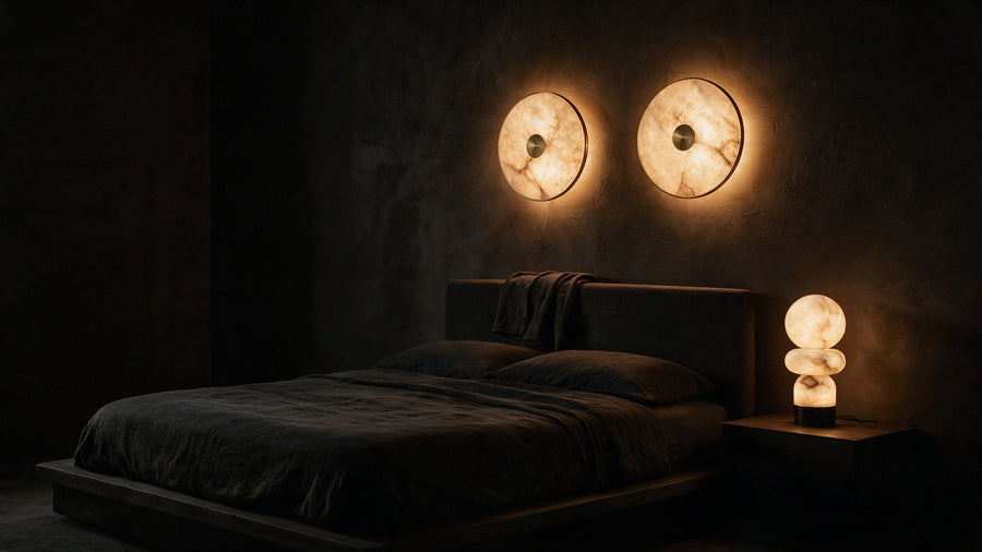A bedroom with warm alabaster light beside the bed