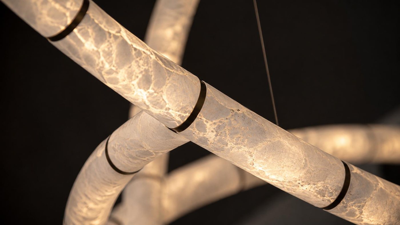 Close-up of illuminated alabaster modules joined by a metal collar