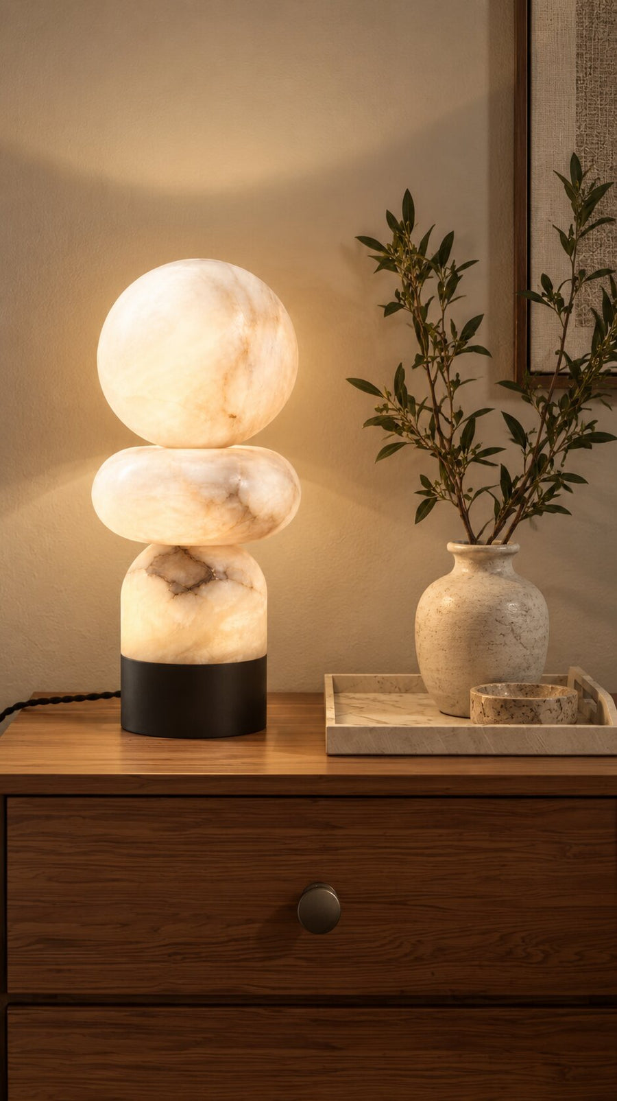 Totem Table Lamp, stacked alabaster forms glowing on a table