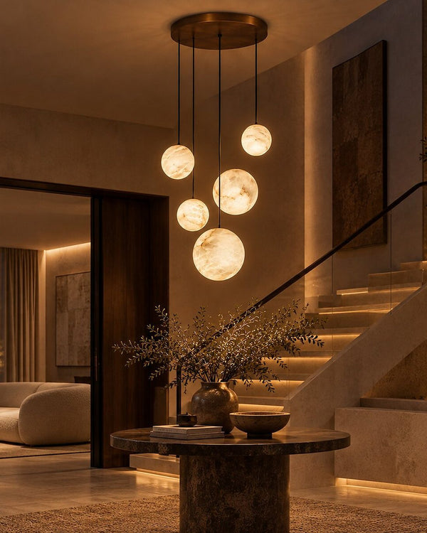 A cluster of alabaster sphere pendants beside a stair at dusk